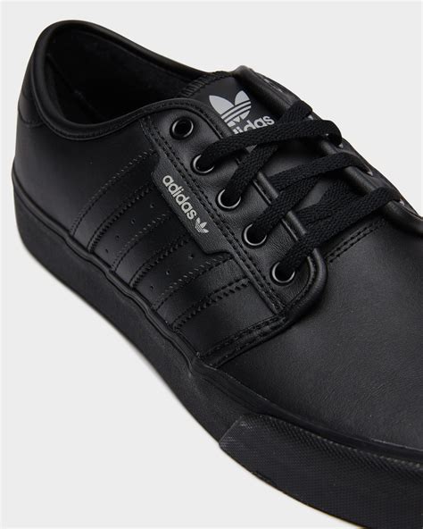 solid black adidas shoes.